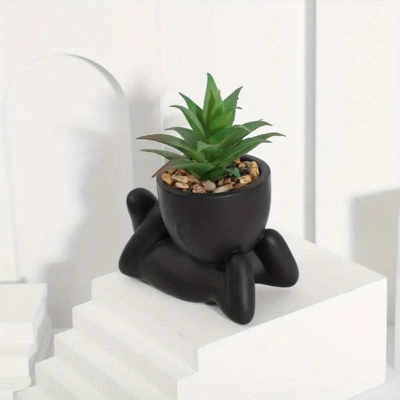 piantine artificiali, vasi a forma di omino, piantine in vaso, piantine finte, decorazioni originali, piantine arredamento casa, piantine in vaso plastica nera, piantine posizioni diverse, piantine moderne, piante decorative senza manutenzione.
