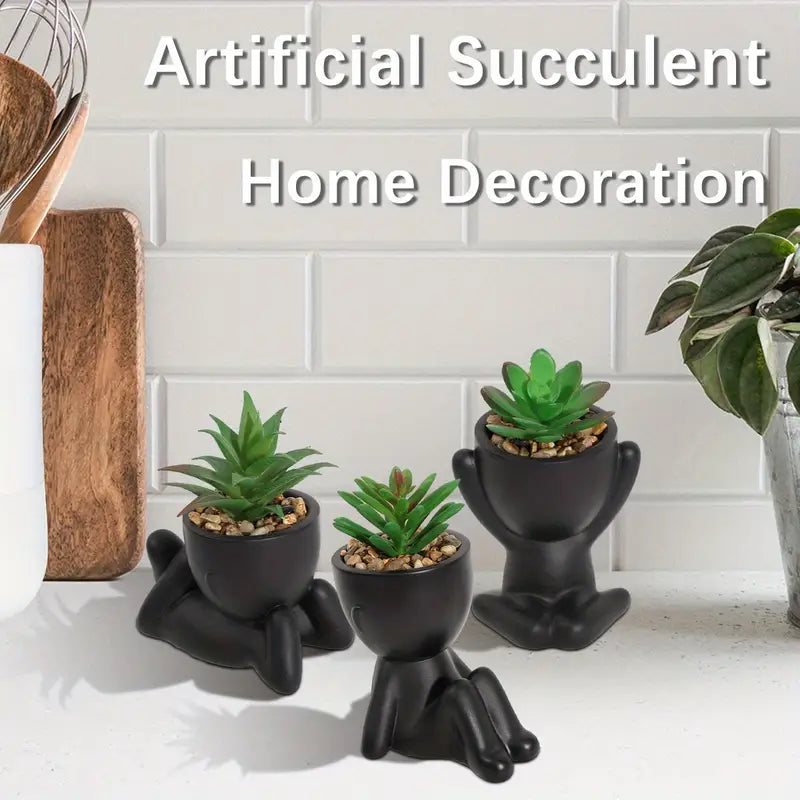 piantine artificiali, vasi a forma di omino, piantine in vaso, piantine finte, decorazioni originali, piantine arredamento casa, piantine in vaso plastica nera, piantine posizioni diverse, piantine moderne, piante decorative senza manutenzione.