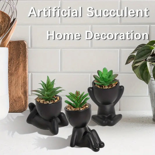 piantine artificiali, vasi a forma di omino, piantine in vaso, piantine finte, decorazioni originali, piantine arredamento casa, piantine in vaso plastica nera, piantine posizioni diverse, piantine moderne, piante decorative senza manutenzione.